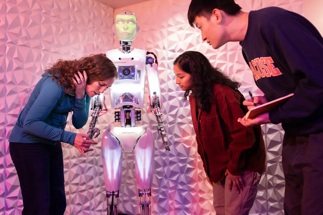 Students work with Professor Jamie Banks and their AI robot Ray, to reserach AI technology in the Link lab in Hinds Hall.